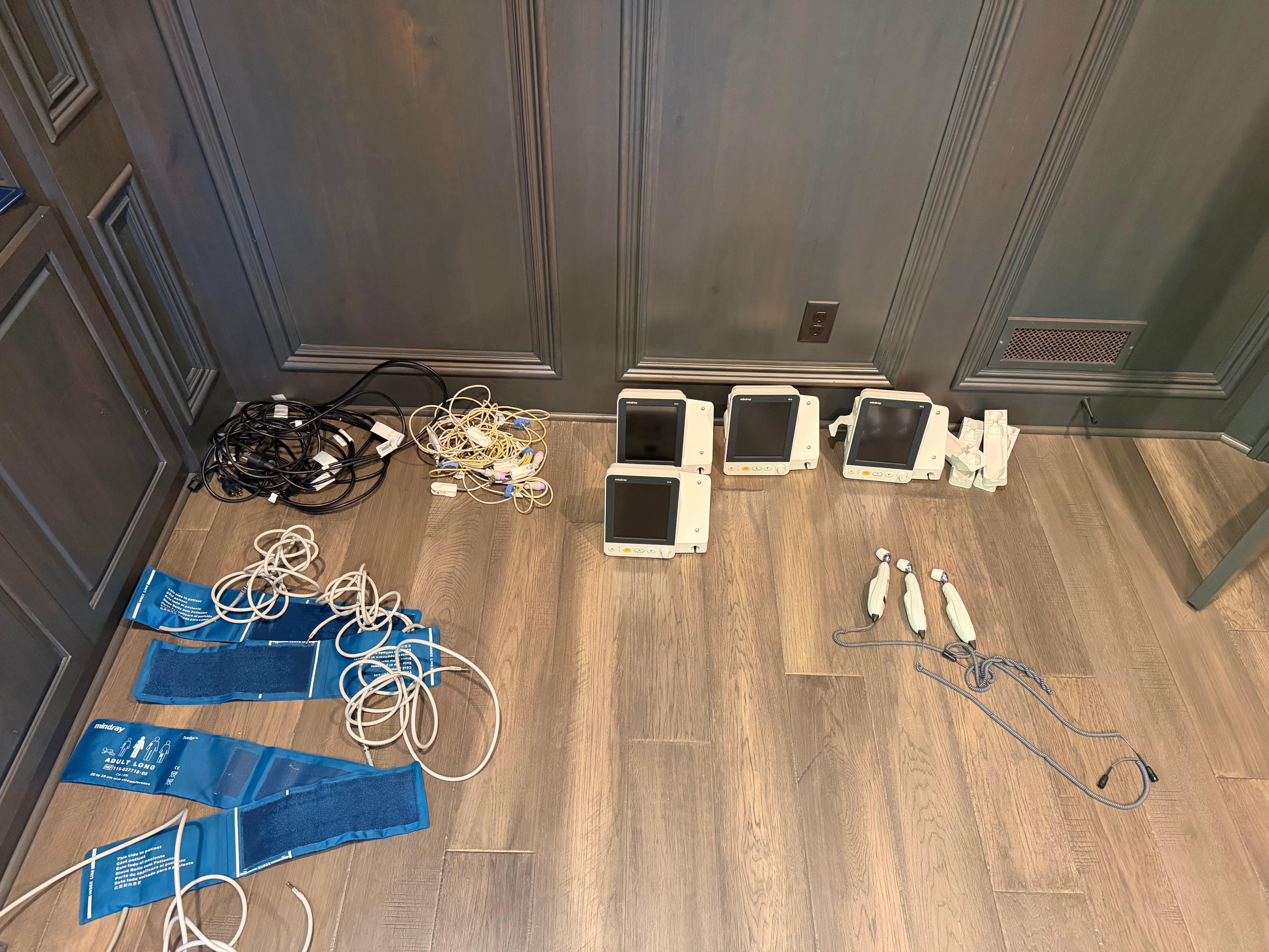 Full spread of four Mindray monitors with cables, BP cuffs, and temporal scanners